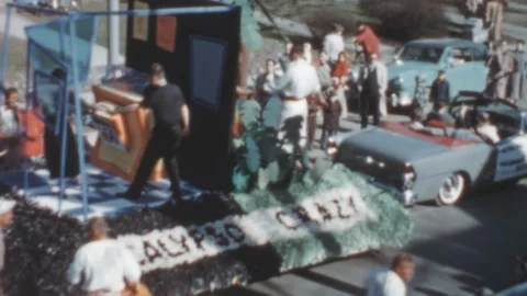 USA - 1950s: people watch a float named Calypso Crazy during a parade Stock Footage 258215596