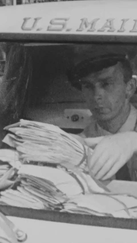 USA - 1950s - A postal worker shows the different compartments for carrying mail Stock Footage 340296884