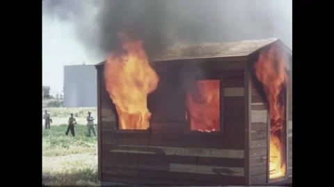USA - 1950s - Three structures are set on fire for a fire test and burn. Stock Footage 327744581