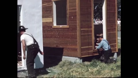 USA - 1950s - Three structures are set on fire with piles of wood inside for a Stock Footage 327746683
