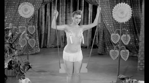 USA - 1953 - A burlesque performer concludes her act by dancing around a swing Stock Footage 337889409