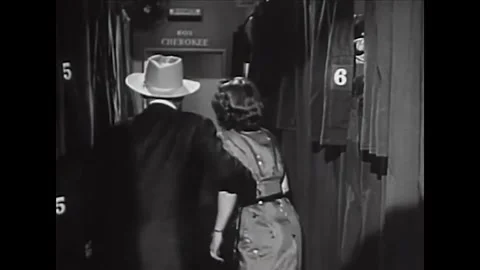 USA - 1953 - In this comedy, a man and woman enter a baggage room and a man Stock Footage 341991855
