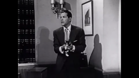 USA - 1953 - In this comedy, a man hides a kitten in an office, putting it into Stock Footage 341991749