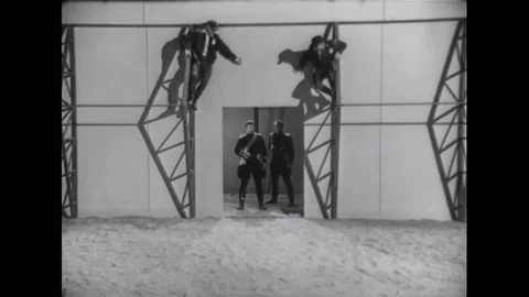 USA - 1954 - In this adventure sci-fi film, two men climb ladders and jump down Stock Footage 327740110