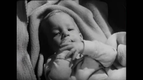 USA - 1954 - In this adventure sci-fi film, a scientist plays with a baby in a Stock Footage 327747061