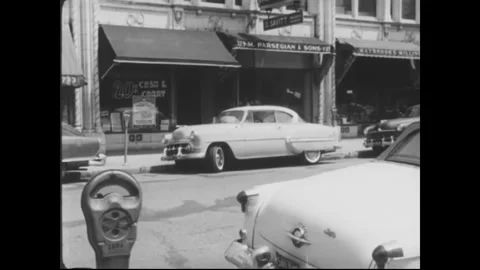 USA - 1954 - A driver has to consult multiple road signs before determining that Stock Footage 340668858