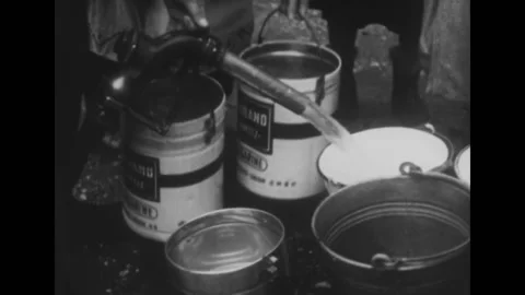 USA - 1955 - Fuel is distributed in buckets and clothes are given out. Children Vídeo Stock 328185408