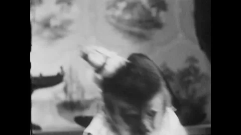 USA - 1955 - A monkey looks at its owner, then jumps to the window. It pushes 스톡 동영상 327752917