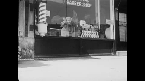 USA - 1955 - A monkey walks down a city street and through a produce stand. He 스톡 동영상 327738173