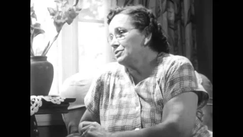 USA - 1955 - A welfare worker checks in on a troubled boy with his foster family Stock Footage 327745330