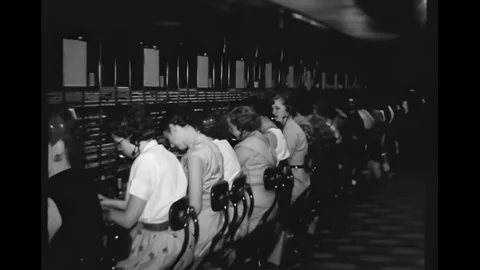USA - 1956 - Long rows of operators patch through long distance phone calls with Stock Footage 323258957
