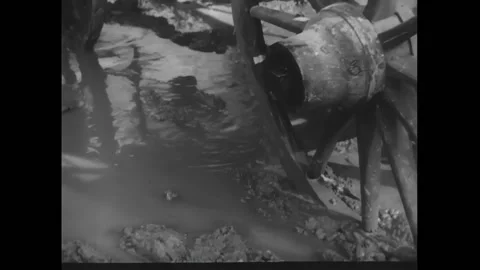 USA - 1956 - In this western, a man throws his wife's piano out of their covered Stock Footage 328181538