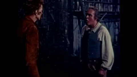 USA - 1956 - In this western, two men argue in a wooden room. Native Americans Stock Footage 325217376