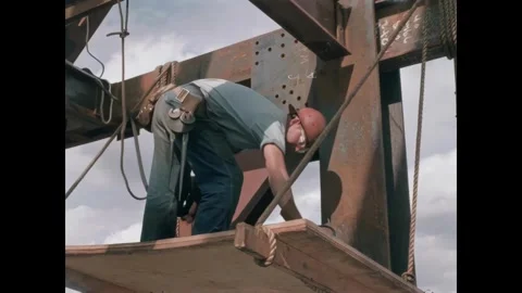 USA - 1957 - A construction worker uses a pneumatic drill and also his hands to Video stock 340667231