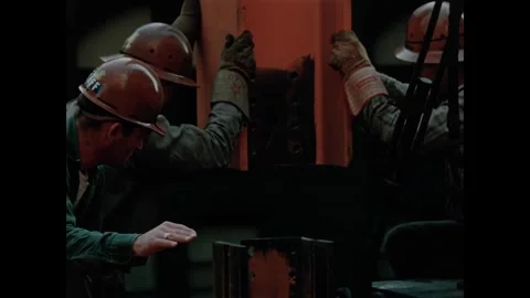 USA - 1957 - Construction workers help lower a steel beam into place by hand. Video stock 340667035