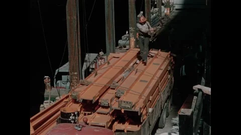USA - 1957 - Construction workers prepare a hoist to pick up a load of steel Stock Footage 340666987