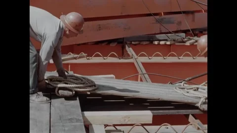 USA - 1957 - Construction workers put wooden platforms onto a rural construction Stock Footage 340667120