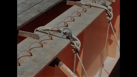 USA - 1957 - Construction workers secure a wooden working platform to a steel Stock Footage 340667061