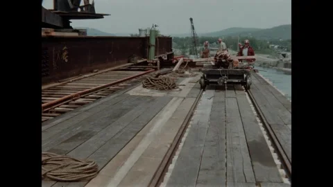 USA - 1957 - Construction workers use a hoist and crane on the building site of Stock Footage 340667079