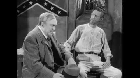 USA - 1957 - In this drama, two men speak in front of a confederate flag. They Stock Footage 325211110