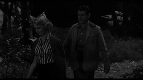 USA - 1958 - In this sci-fi horror, a dirty man looks out and a couple kiss as Stock-Footage 323084039