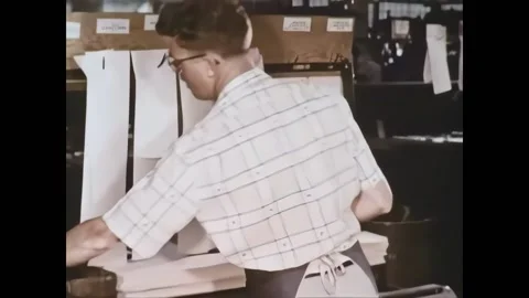 USA - 1959 - A man pulls thin sheets from a printing press. A proofreader Video stock 327742874