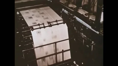 USA - 1959 - Newspapers move through large printing machines. Men work at the Stock Footage 327745950