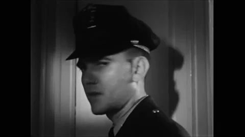 USA - 1960 - Cops arrive at an apartment where a woman has been hit by her Stock Footage 277348089