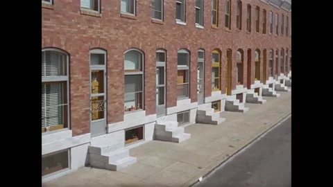 USA - 1960s - Move down a sidewalk row of townhouses and stoops. Stock Footage 277281939