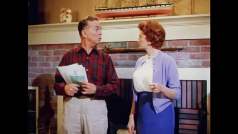 USA - 1961 - A man explains to his wife why the new phone number system excludes Stock Footage 341514215
