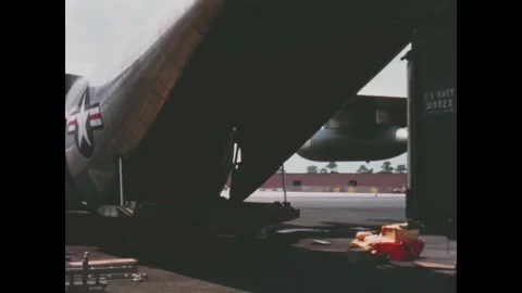 USA - 1964 - US Marines back a truck to the ramp of a KC-130 transport plane and Stock Footage 340588122
