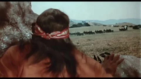 USA - 1964 - In this western, an Apache war party descends down a mountain onto Stock Footage 308175656