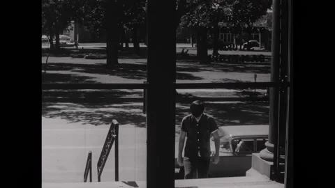 USA - 1966 - A high school dropout enjoys reading fiction at the library, in Stock Footage 323265238