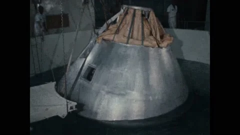 USA - 1966 - A space capsule mock-up is hoisted upside-down and around in a Stock Footage 312874471