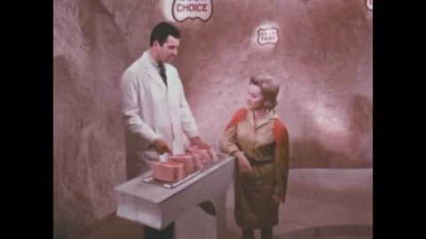 USA - 1967 - A butcher explains the differences among USDA grades of beef to a Stock Footage 340590984