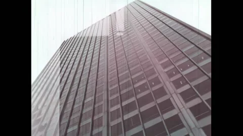USA - 1968 - Elevator goes up a building, and images of buildings are shown. Stock Footage 327751092