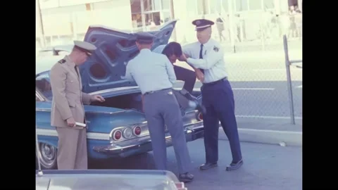 USA - 1968 - US Customs agents check drivers at the US-Mexico border, and detain Stock Footage 296170367