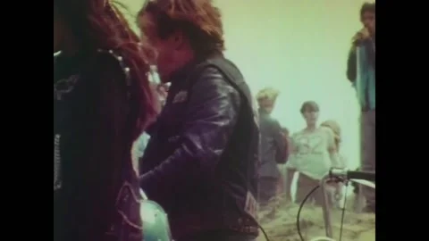 USA - 1969 - Cops keep an eye on a biker gang beach party. Stock Footage 259550722