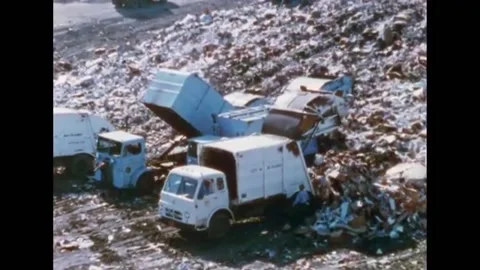 USA - 1970 - Garbage is compacted and covered with soil at a sanitary landfill. Stock Footage 284817742