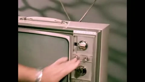 USA - 1970 - A hand turns knobs on television screen, and the screen is shown. 스톡 동영상 327735326