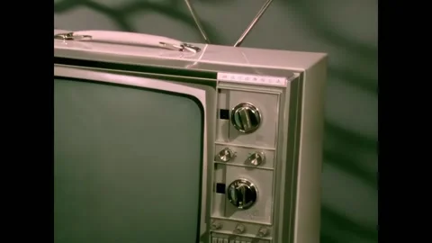 USA - 1970 - A TV with silver knobs is shown, and a hand turns the knobs. Video stock 327751136