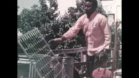 USA - 1970s - A man builds a platform for his outdoor garbage cans to keep rats Video stock 340581520
