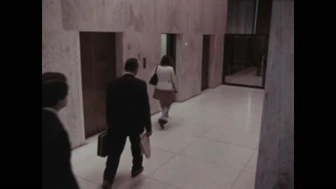 USA - 1970s - A timelapse of people using elevators in an office building helps Stock Footage 330670634