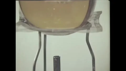 USA - 1972 - Close-up of steam hitting the straws of myriad flasks in a chemical Stock Footage 340663824