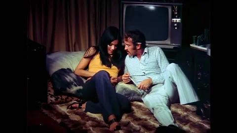 USA - 1972 - In this horror sci-fi, a man and woman talk on the floor of a 70s Video stock 325211738