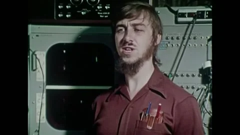 USA - 1972 - A man stands in front of an oscillating screen. He talks about Stock Footage 327741423