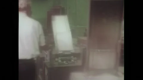 USA - 1974 - A punch card computer is used and a man loads cards onto it. Stock Footage 327740602