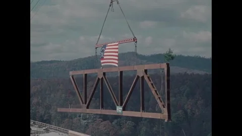 USA - 1976 - Construction workers operate a crane with carrying a bridge section Video stock 340660423