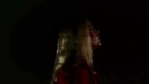 USA - 1977 - In this sci-fi horror, a woman stands outside in the dark and a Stock Footage 327740254