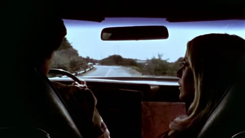 USA - 1977 - In this sci-fi horror, a man and woman drive down a road. A group Stock-Footage 327753086
